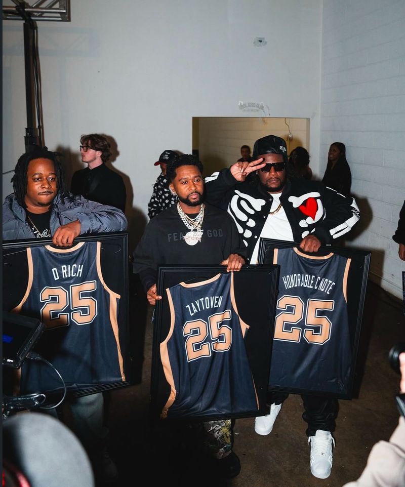 Honorees holding framed number 25 jerseys